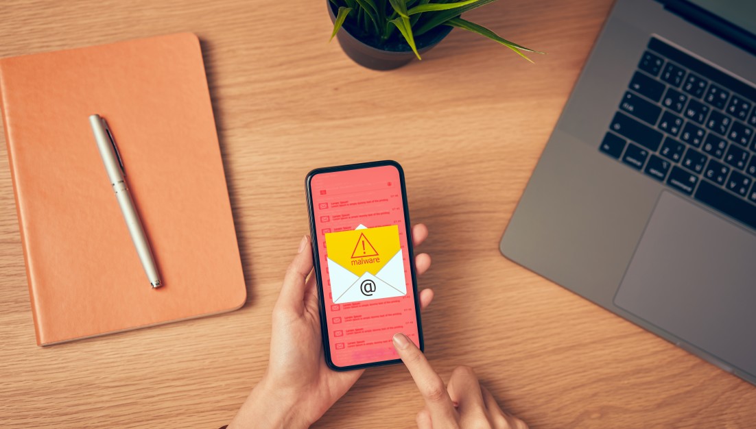 concept-of-cyber-crime-hand-holding-smartphone-and-show-malware-screen-that-comes-with-email-hack