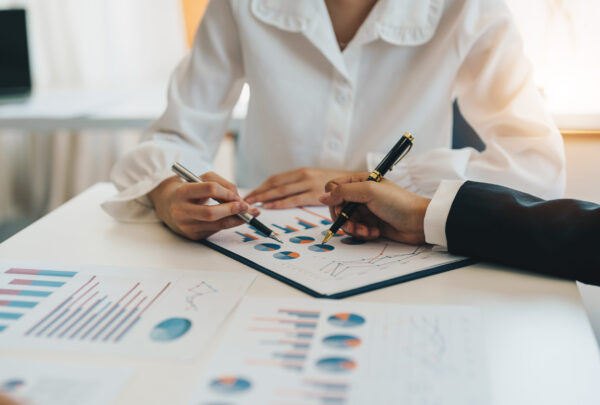 Close up business team hands at working with financial plan, meeting, discussion, brainstorming on the office desk,